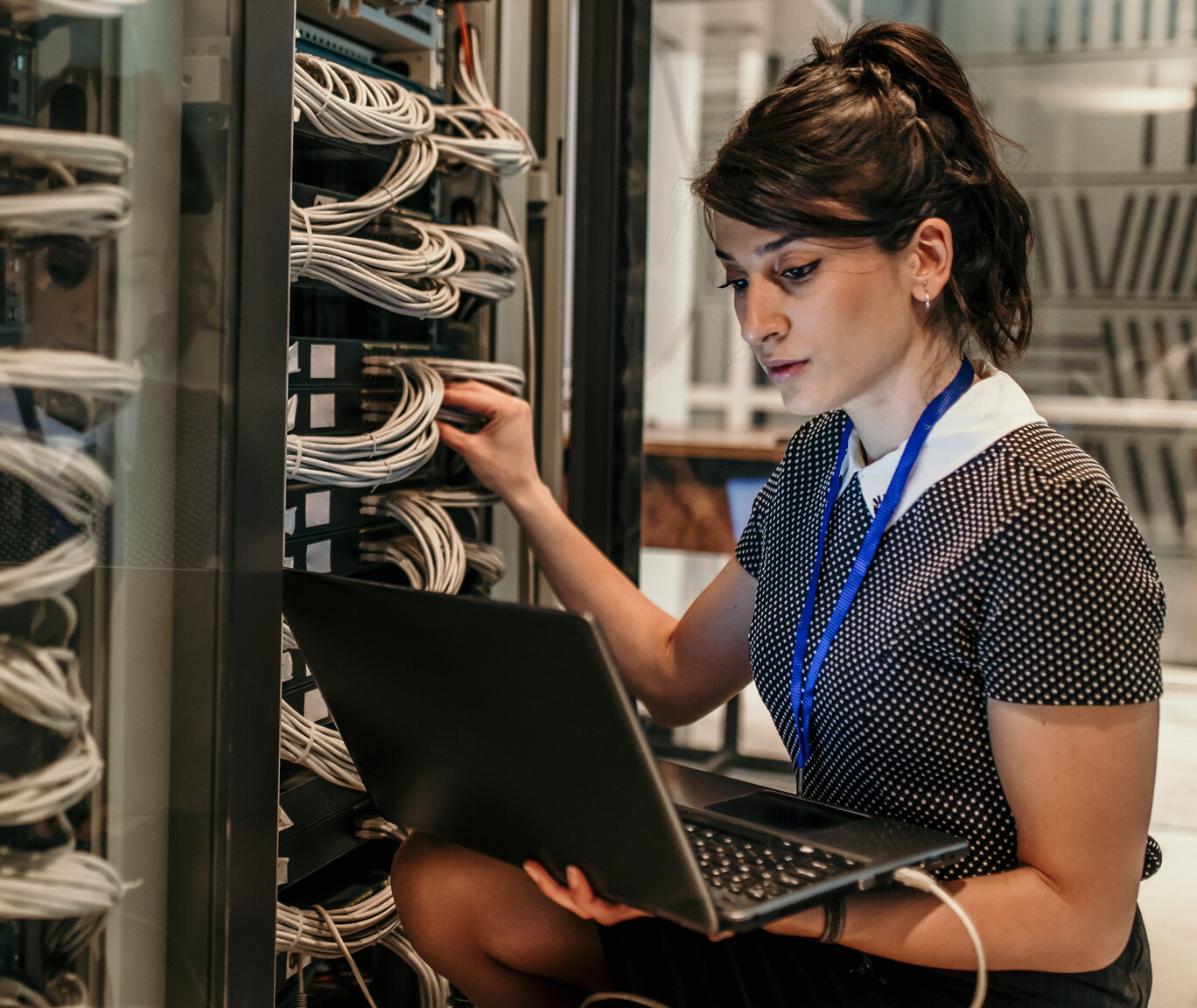 Female IT Engineer Working in Server Room