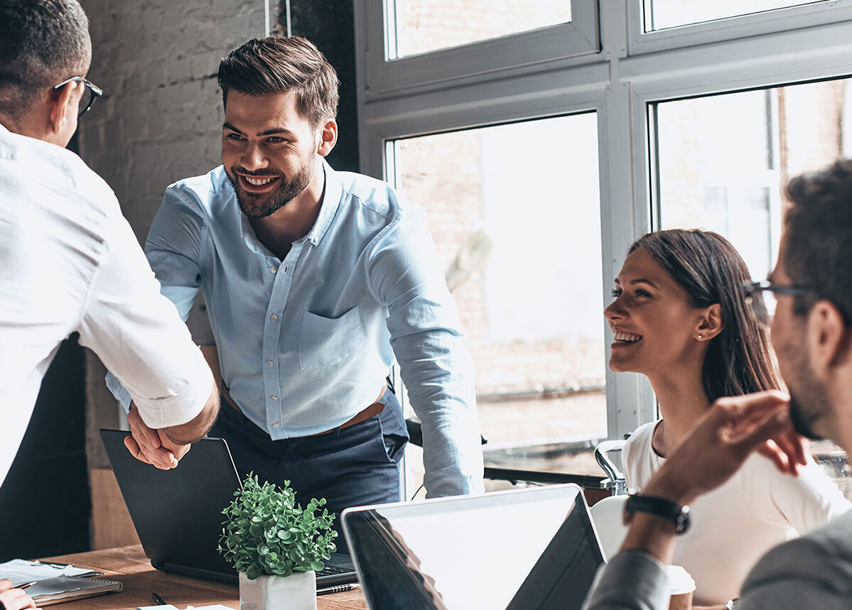 Employees sitting round a table in a collaborative session